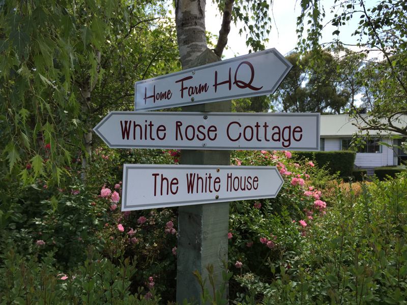The signpost to Home Farm HQ, White Rose Cottage and The White House