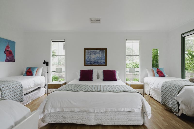 A bedroom with queen and single beds