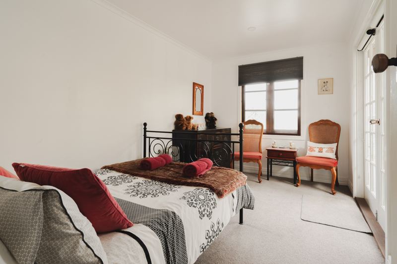 A bedroom with reading chairs
