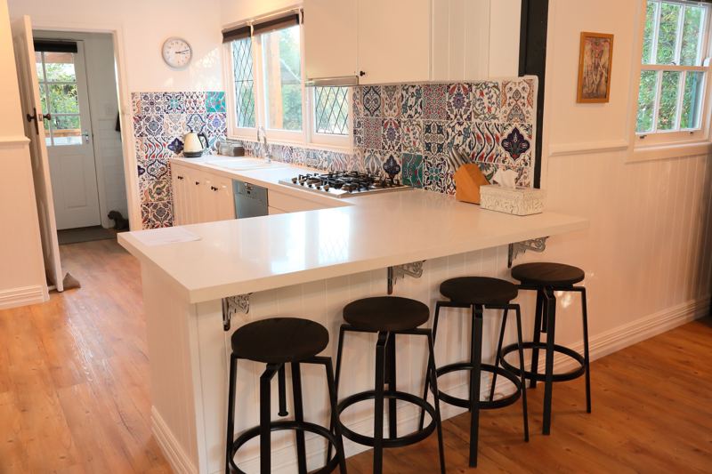 The kitchen with tiled splashback