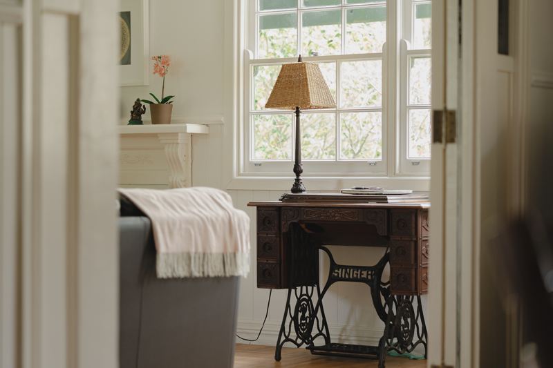 An antique sewing table by the window